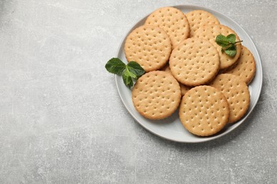 Photo of Tasty sandwich cookies on light gray textured table, top view. Space for text