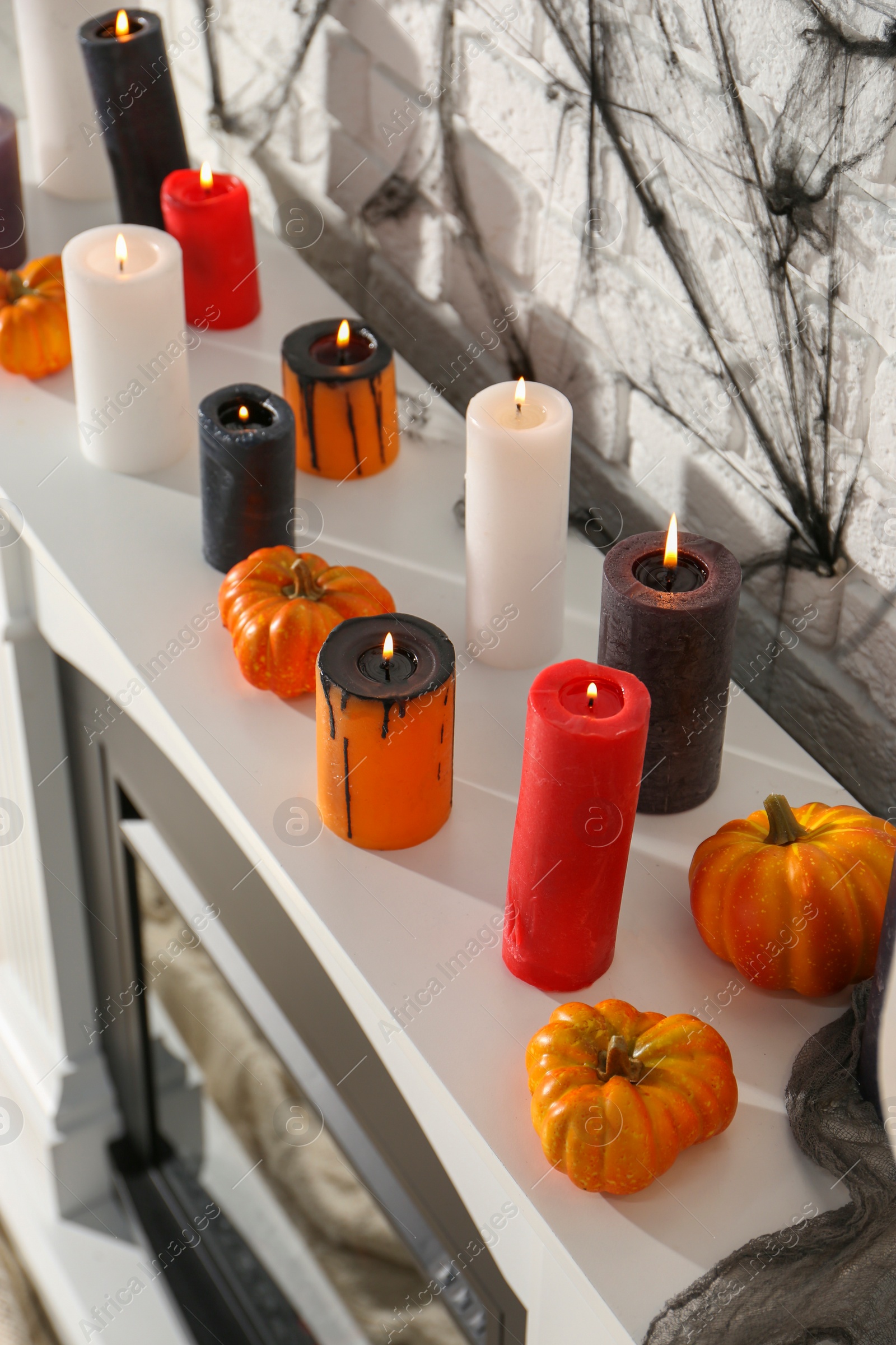 Photo of Fireplace with different Halloween decor indoors, above view. Festive interior