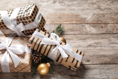 Photo of Beautiful composition with gift box and Christmas decorations on wooden table