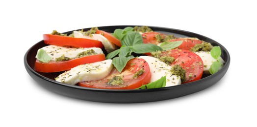 Photo of Plate of delicious Caprese salad with pesto sauce isolated on white