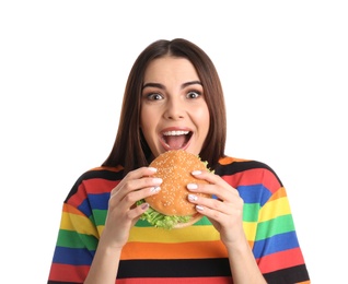 Photo of Young woman eating tasty burger on white background