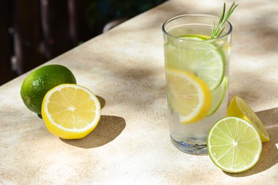 Photo of Summer refreshing lemonade and ingredients on light table, space for text