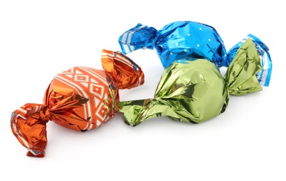 Sweet candies in colorful wrappers on white background