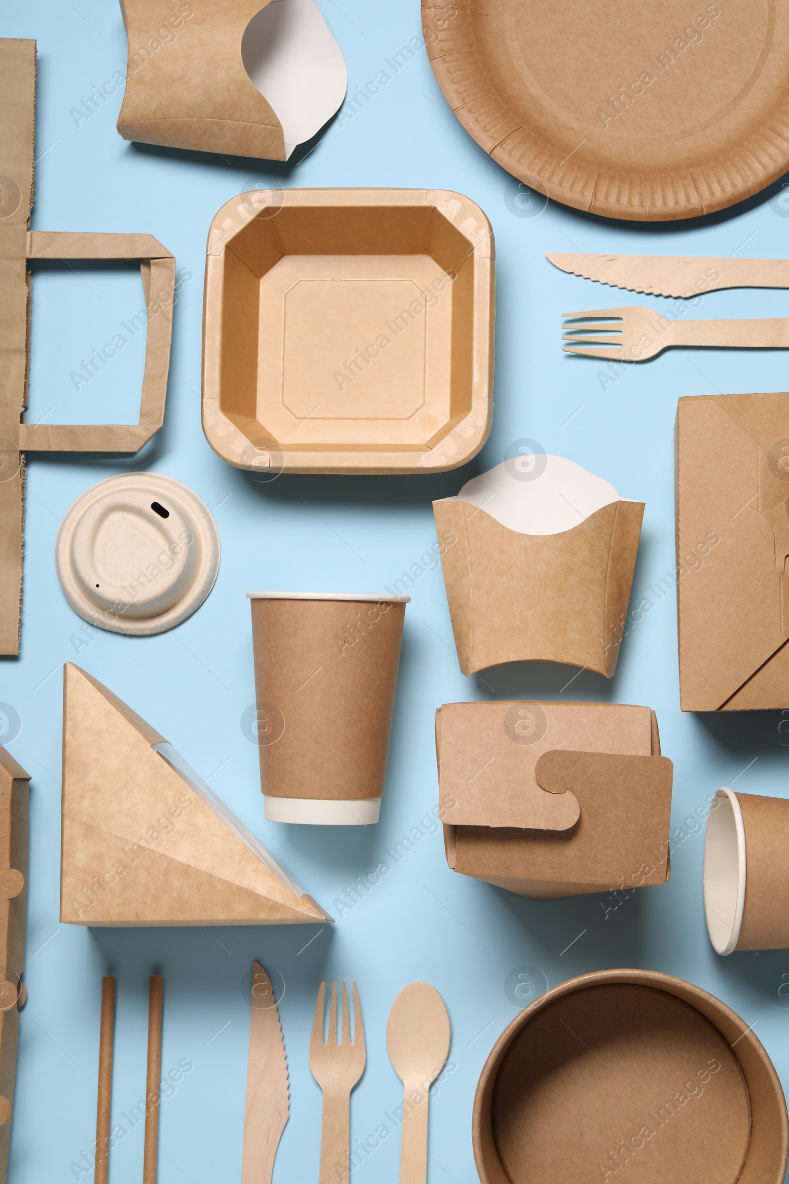 Photo of Flat lay composition with eco friendly food packagings on light blue background