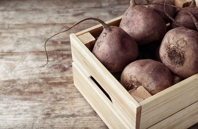 Photo of Box with whole fresh beets on wooden table