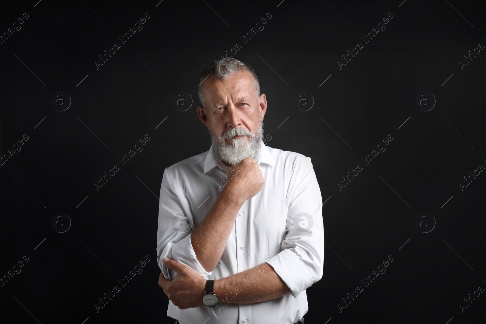 Photo of Portrait of handsome senior man on black background