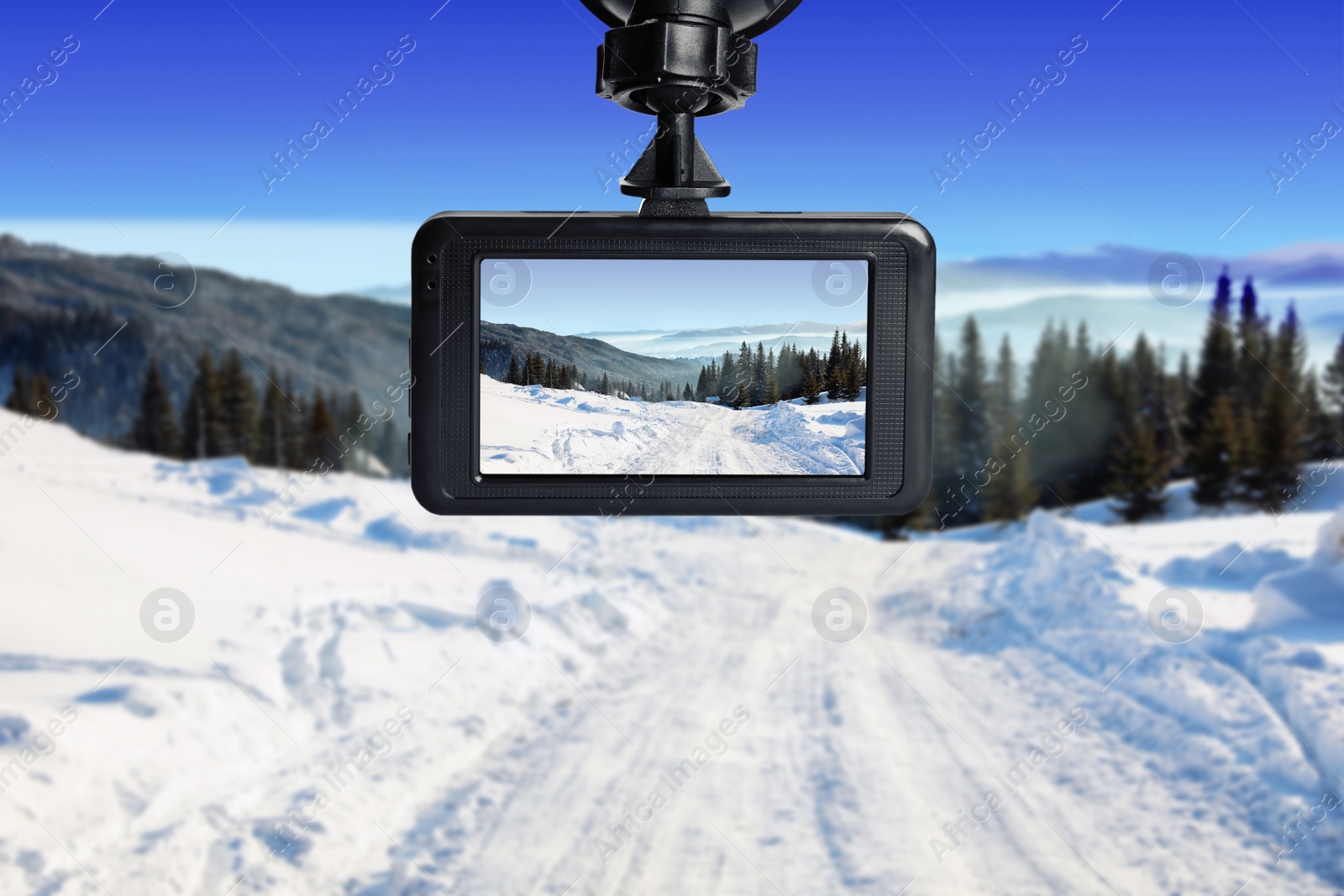 Image of Modern dashboard camera mounted in car, view of road during driving