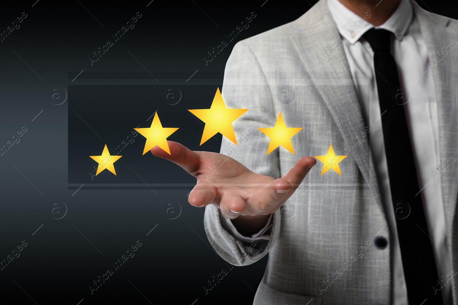 Image of Quality evaluation. Businessman showing virtual golden stars on black background, closeup