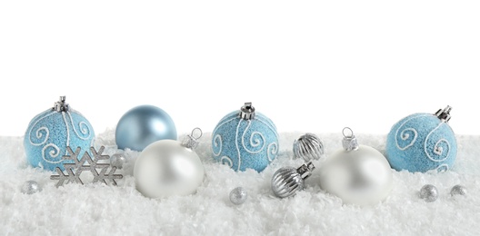 Photo of Christmas tree decoration on artificial snow against white background