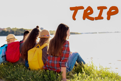 Group of children with backpacks on coast. Summer trip