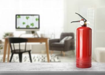 Image of Fire extinguisher on stone table in living room. Space for text