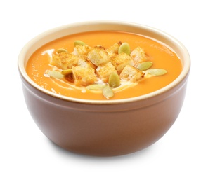 Photo of Tasty creamy pumpkin soup with croutons and seeds  in bowl on white background