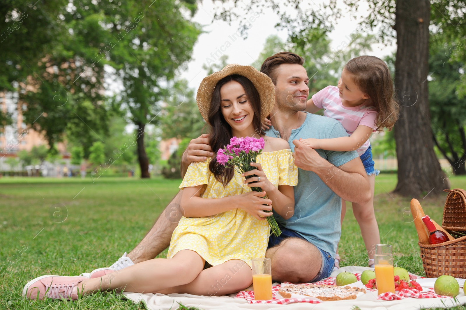 Photo of Happy family having picnic in park on summer day