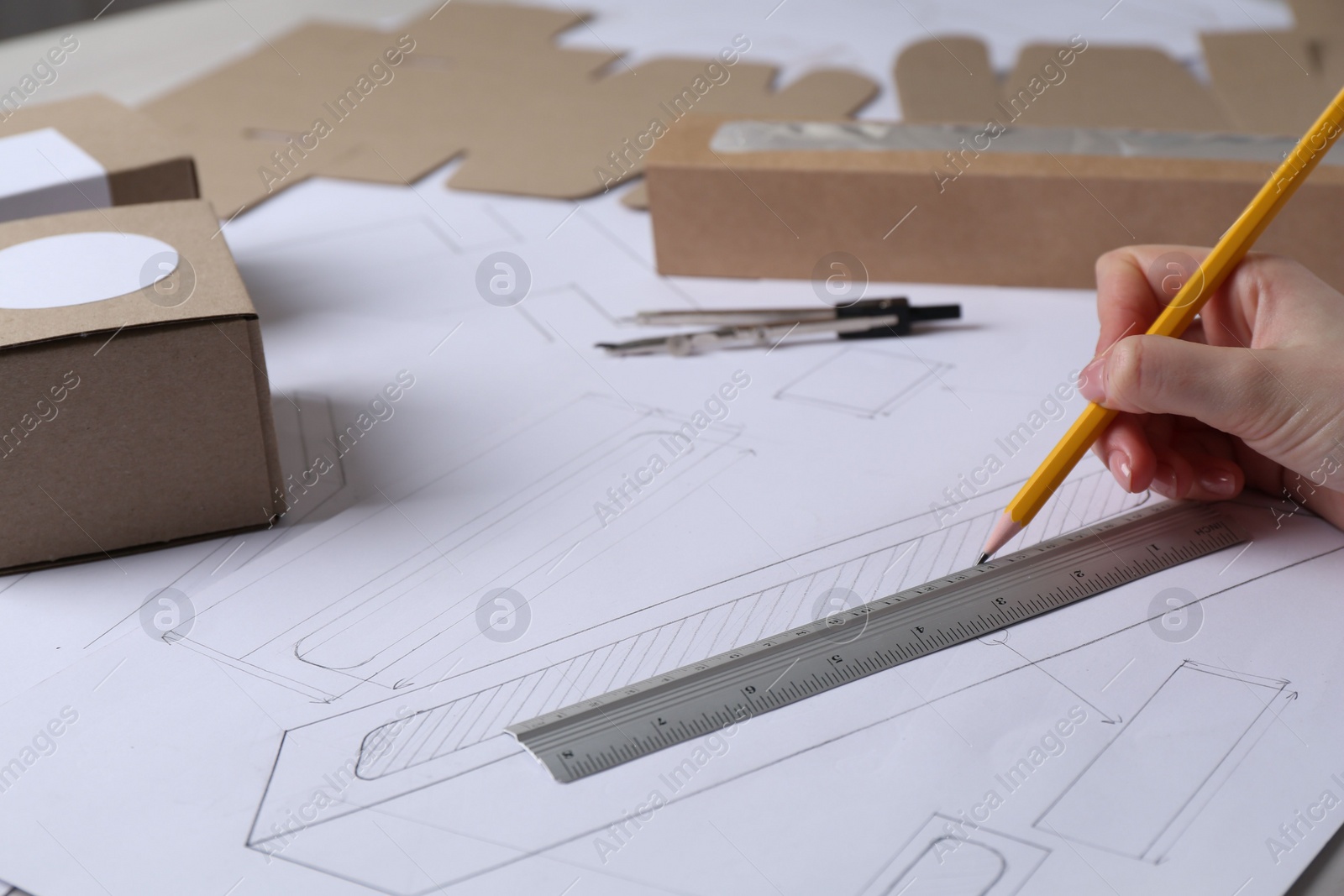 Photo of Woman creating packaging design on paper, closeup