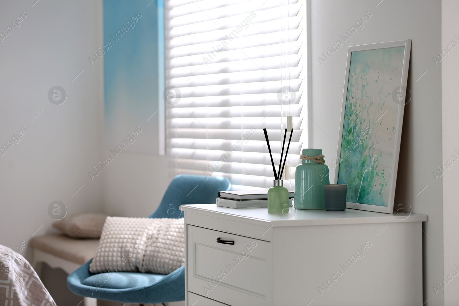 Photo of Modern room interior with white chest of drawers