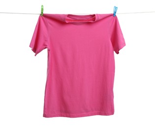 Photo of Pink t-shirt drying on washing line against white background