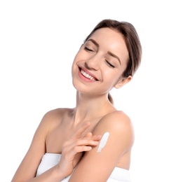 Photo of Young woman applying cream on white background. Beauty and body care