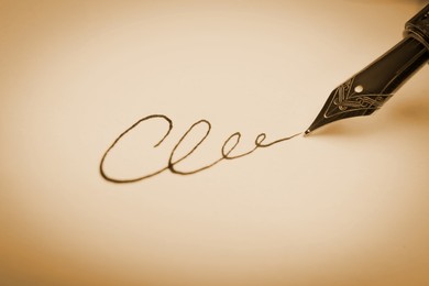 Image of Signing on sheet of paper with fountain pen, closeup