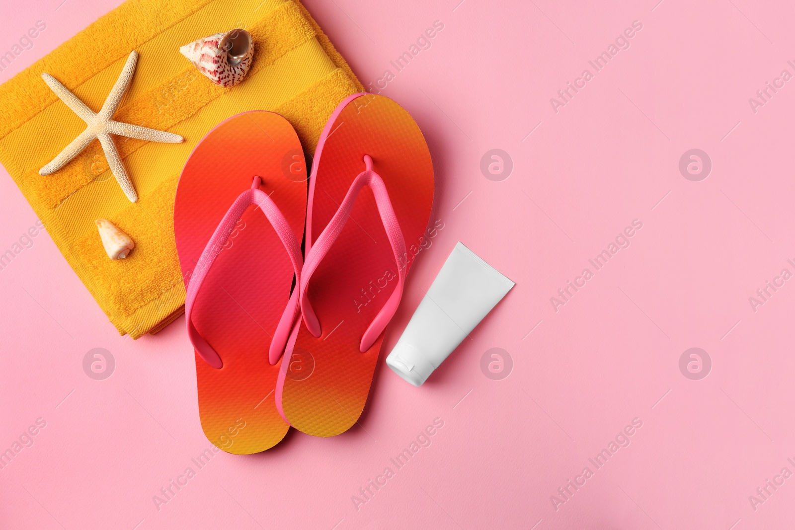 Photo of Sunscreen and beach accessories on pink background, flat lay with space for text