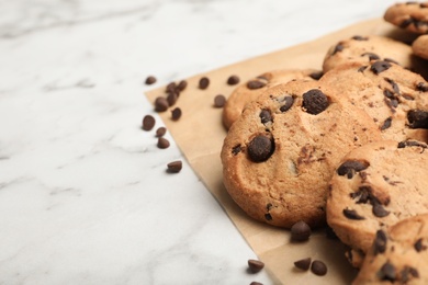 Photo of Tasty chocolate cookies on marble table, closeup