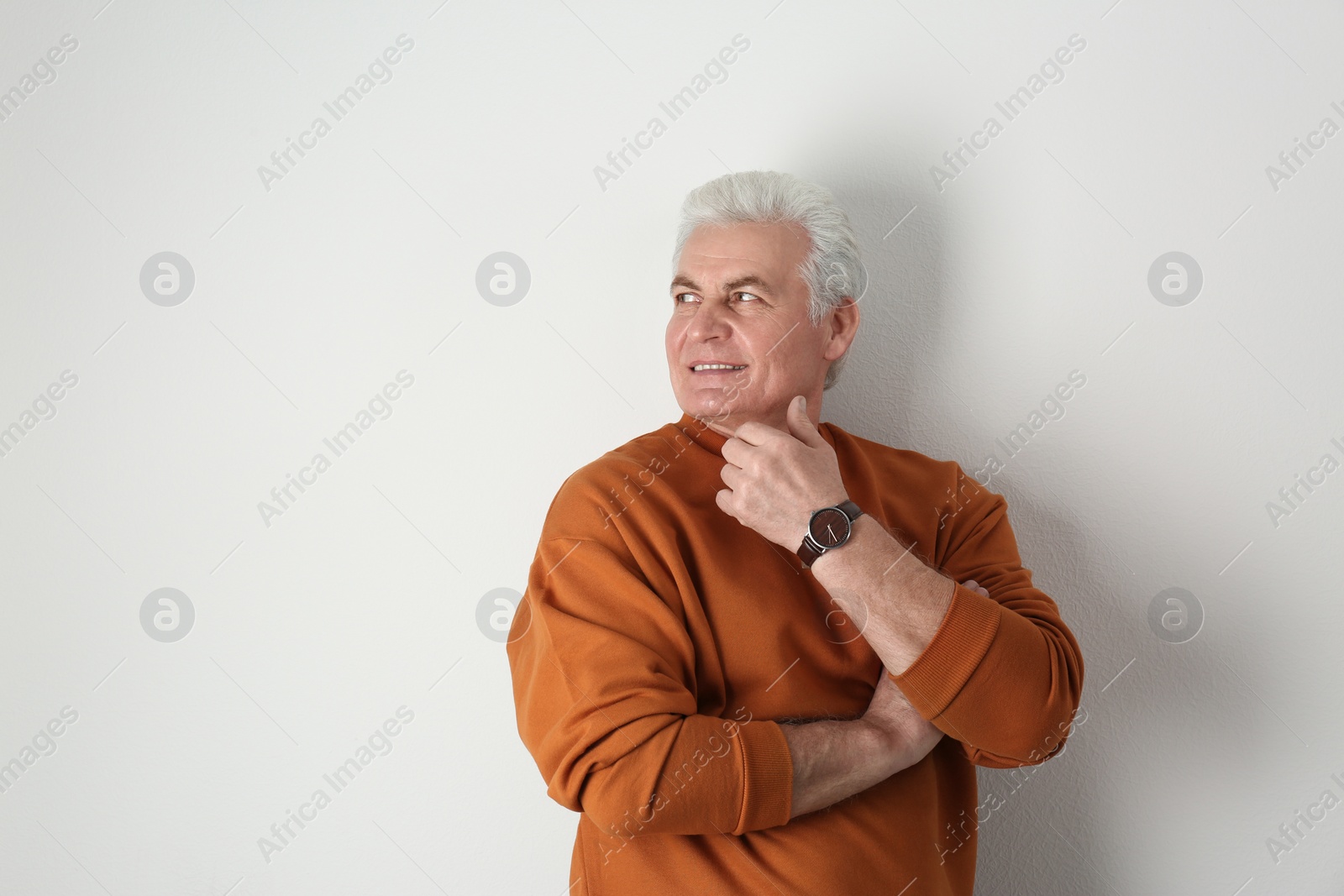 Photo of Portrait of handsome mature man on light background. Space for text