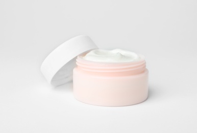 Photo of Jar of cosmetic product on light background