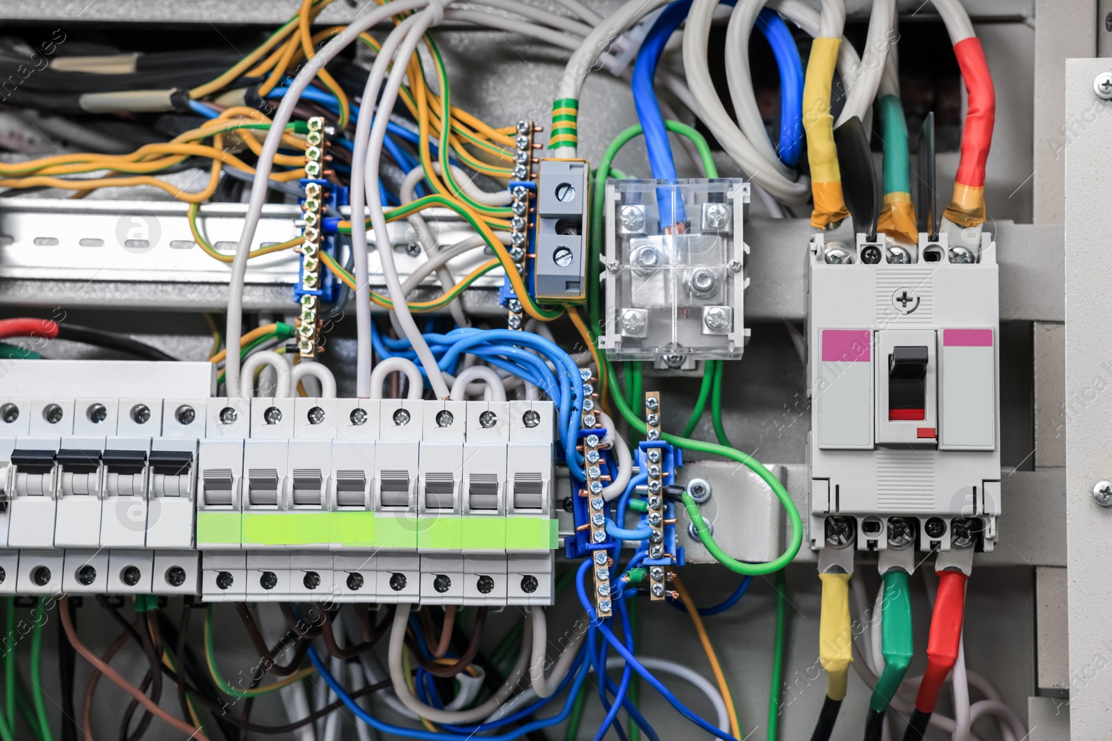 Photo of Electrical panel with many wires in fuse box, closeup