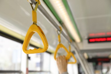 Photo of Grab pole with handgrip handles in public transport