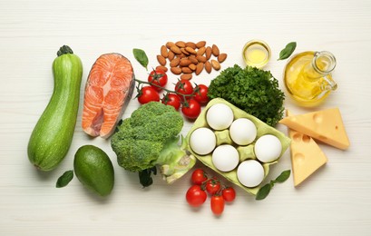 Photo of Flat lay composition with fresh organic products on white wooden table. Keto diet