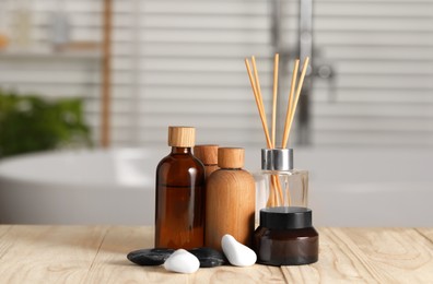 Photo of Composition with spa products on wooden table in bathroom