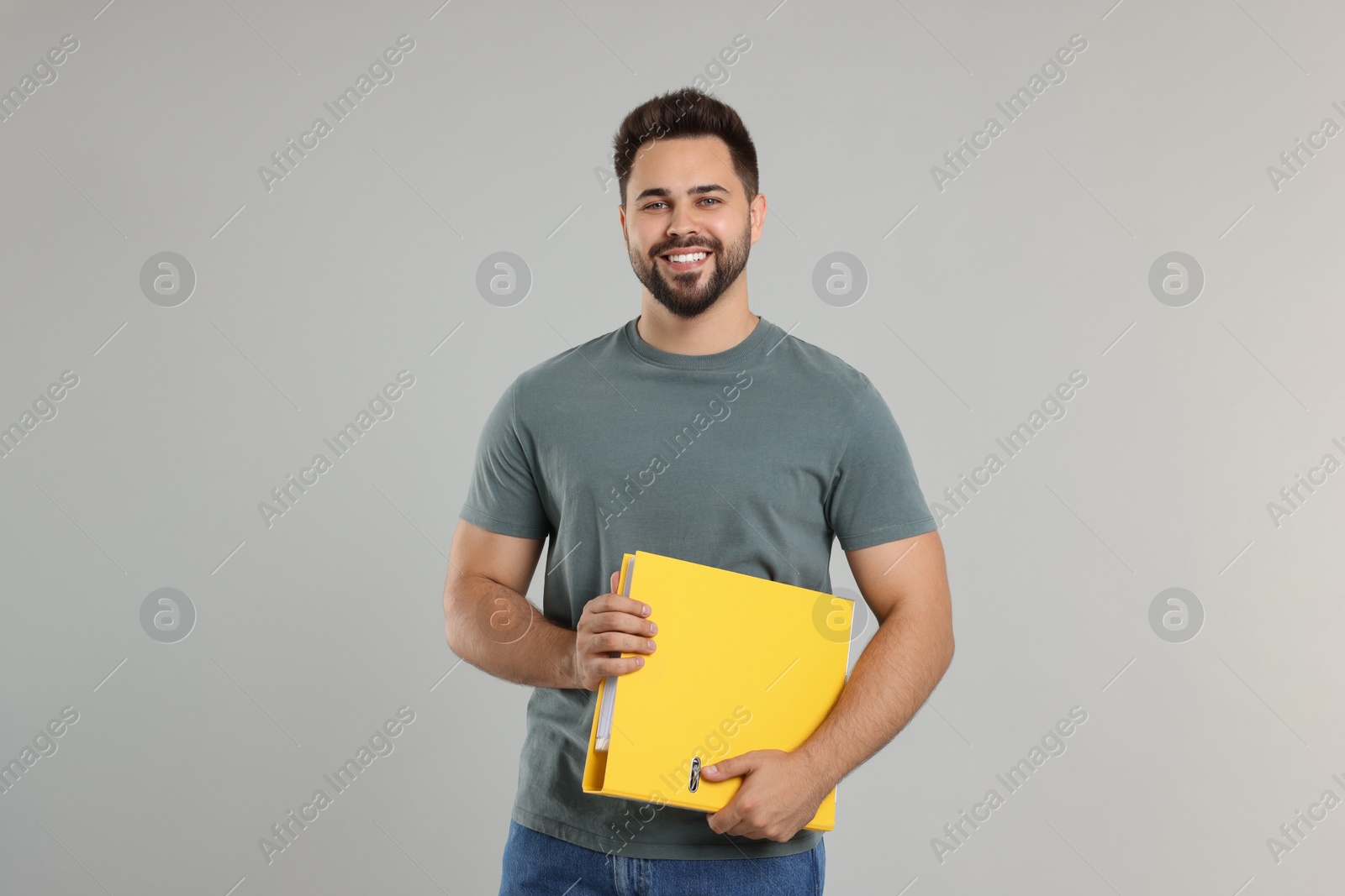 Photo of Happy man with folder on light gray background