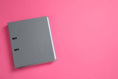 Photo of Grey office folder on pink background, top view. Space for text