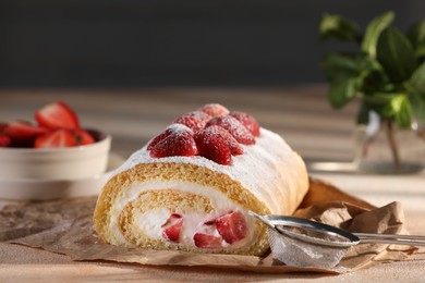 Delicious cake roll with strawberries and cream on table, closeup