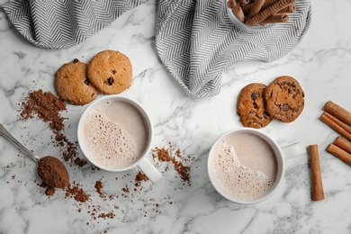 Flat lay composition with hot cocoa drink and cookies on light background