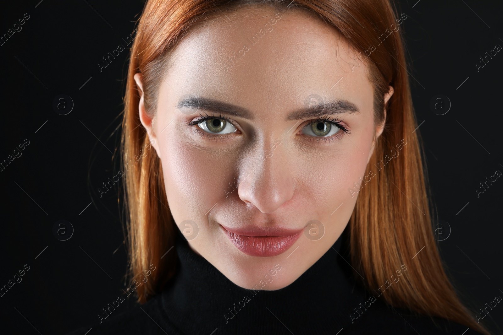 Photo of Evil eye. Young woman with scary eyes on black background, closeup