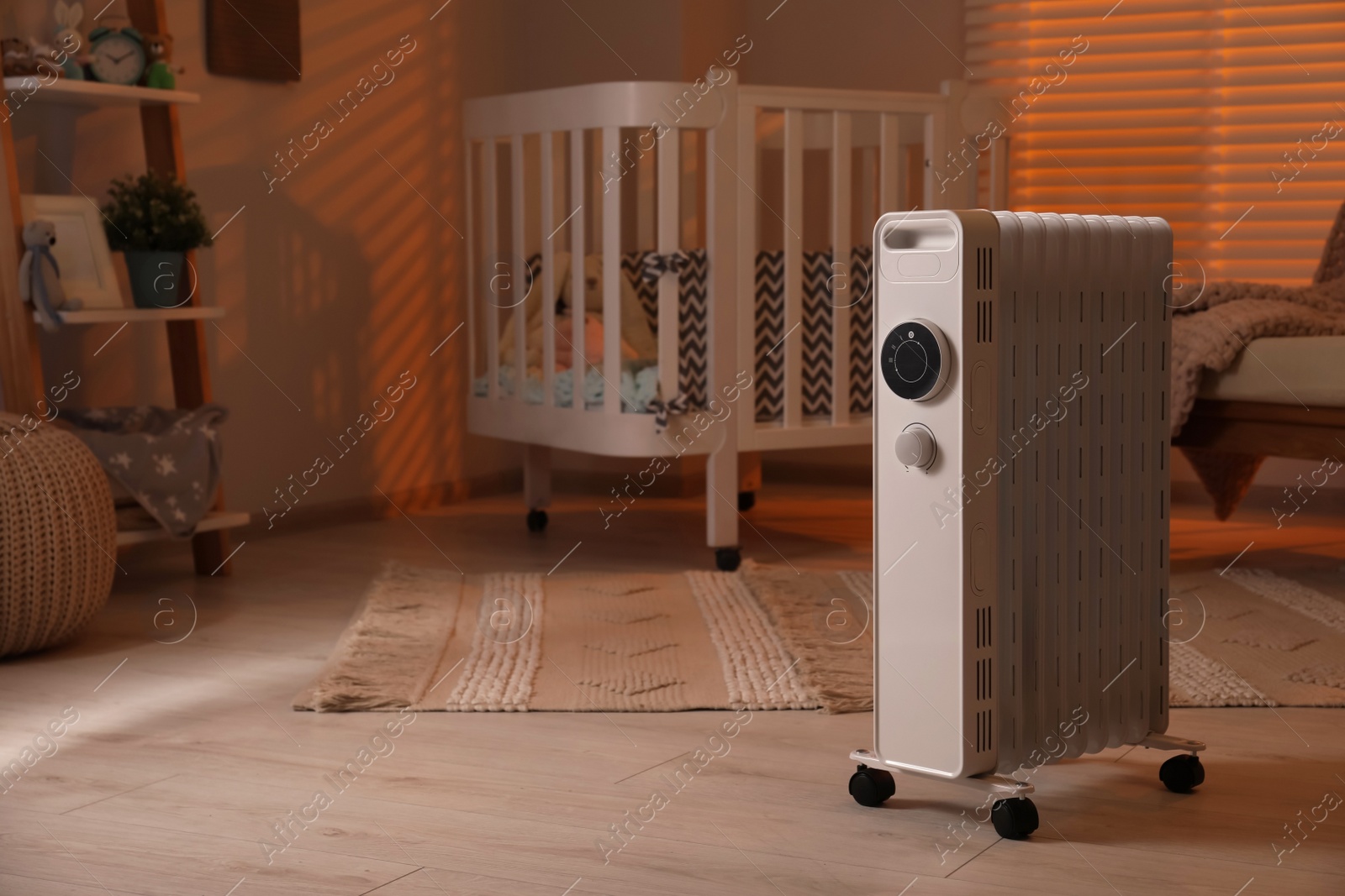 Photo of Modern portable electric heater in child room, space for text