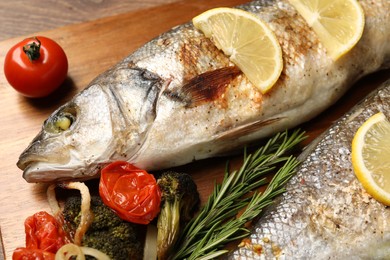 Photo of Delicious baked fish and vegetables on table, closeup