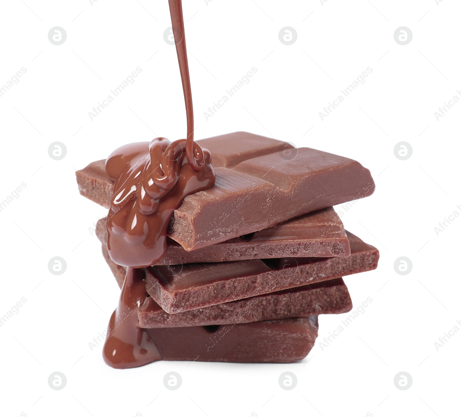 Photo of Pouring tasty milk chocolate paste onto pieces isolated on white