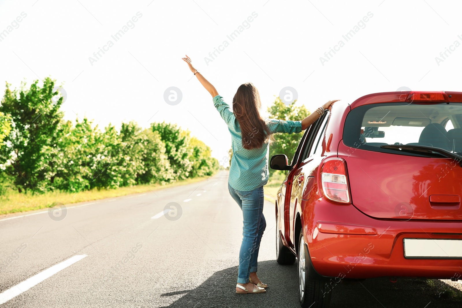 Photo of Young woman near car outdoors on sunny day