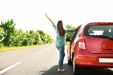 Young woman near car outdoors on sunny day