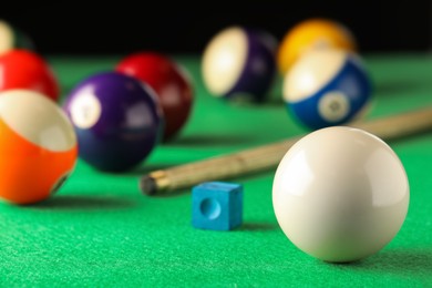 Photo of Classic white billiard ball on green table. Space for text