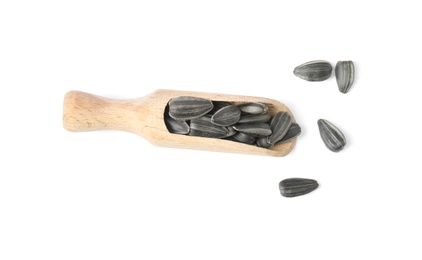 Photo of Raw organic sunflower seeds in wooden scoop isolated on white, top view