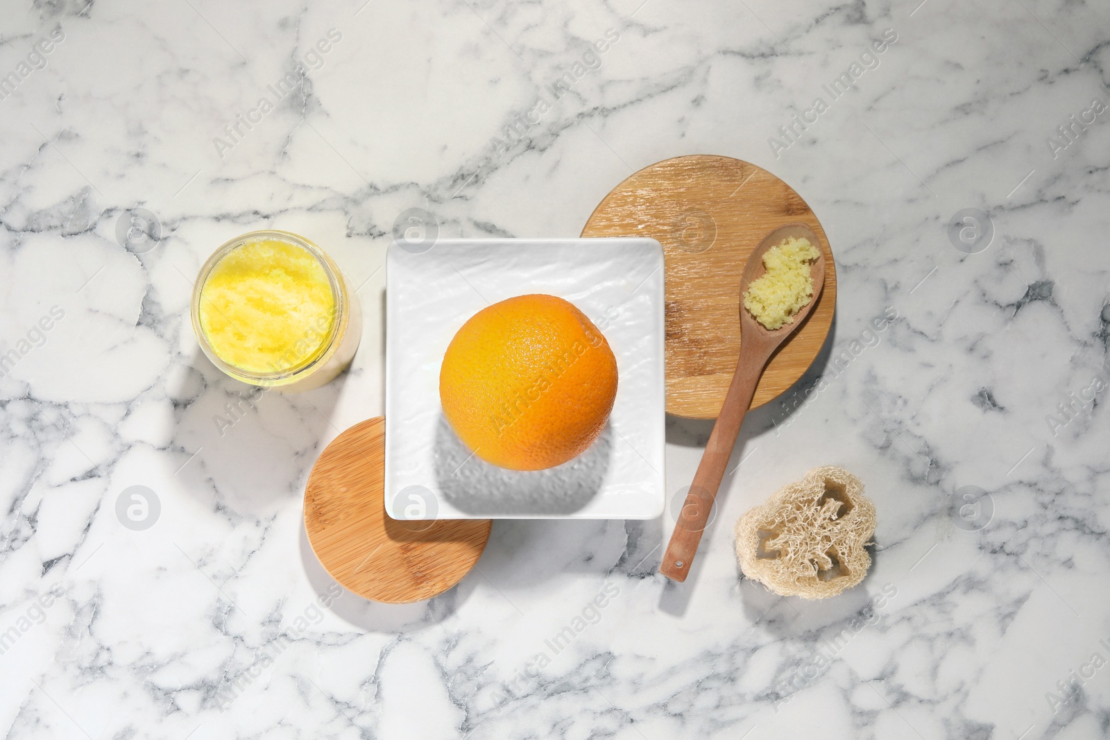 Photo of Natural body scrub, orange and luffa on white marble table, flat lay. Anti cellulite treatment