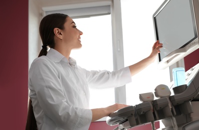 Photo of Sonographer using modern ultrasound machine in clinic