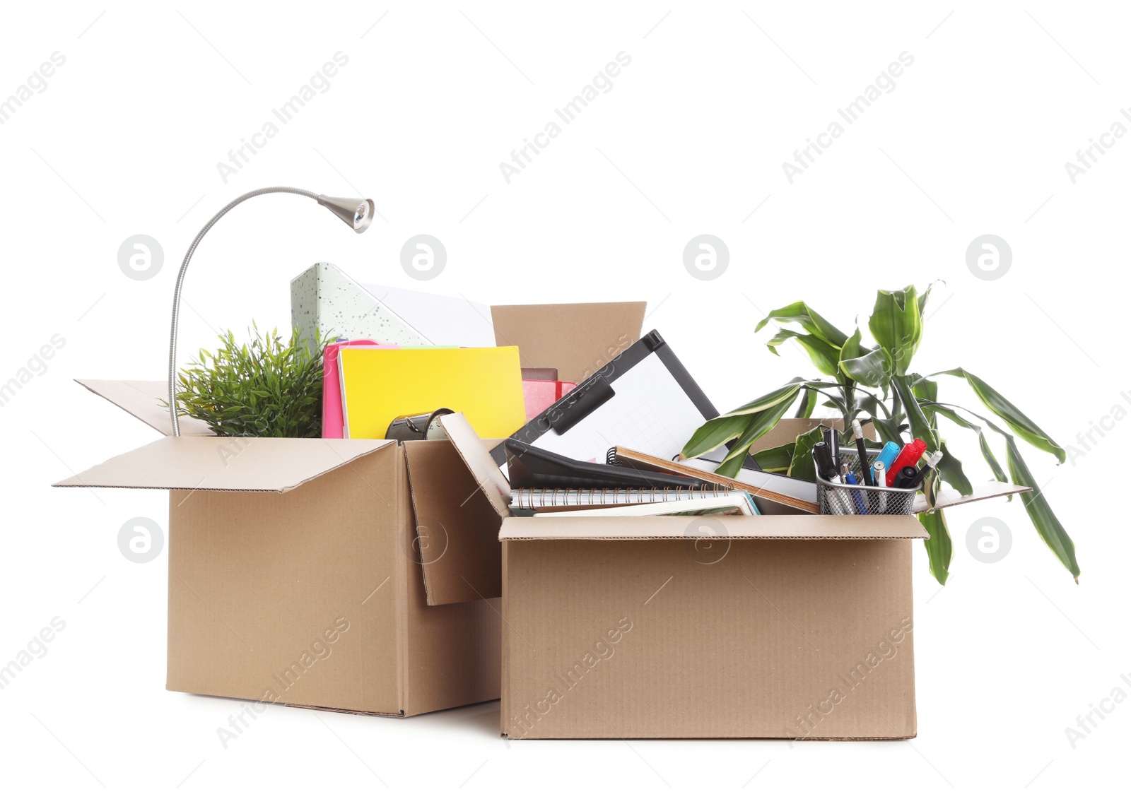 Photo of Cardboard boxes full of office stuff on white background