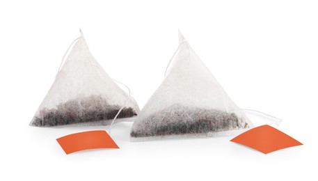 Photo of New pyramid tea bags on white background