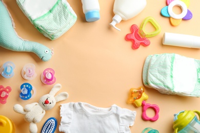 Photo of Flat lay composition with baby accessories and space for text on color background
