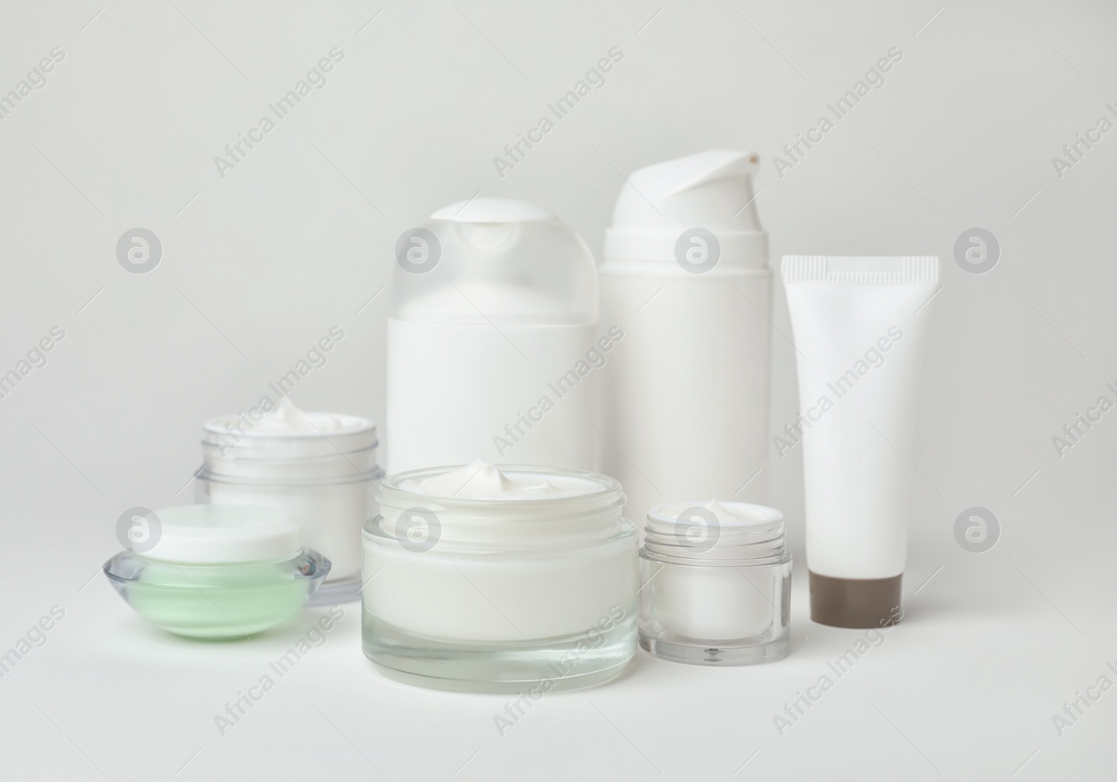 Photo of Composition with cosmetic products on light background