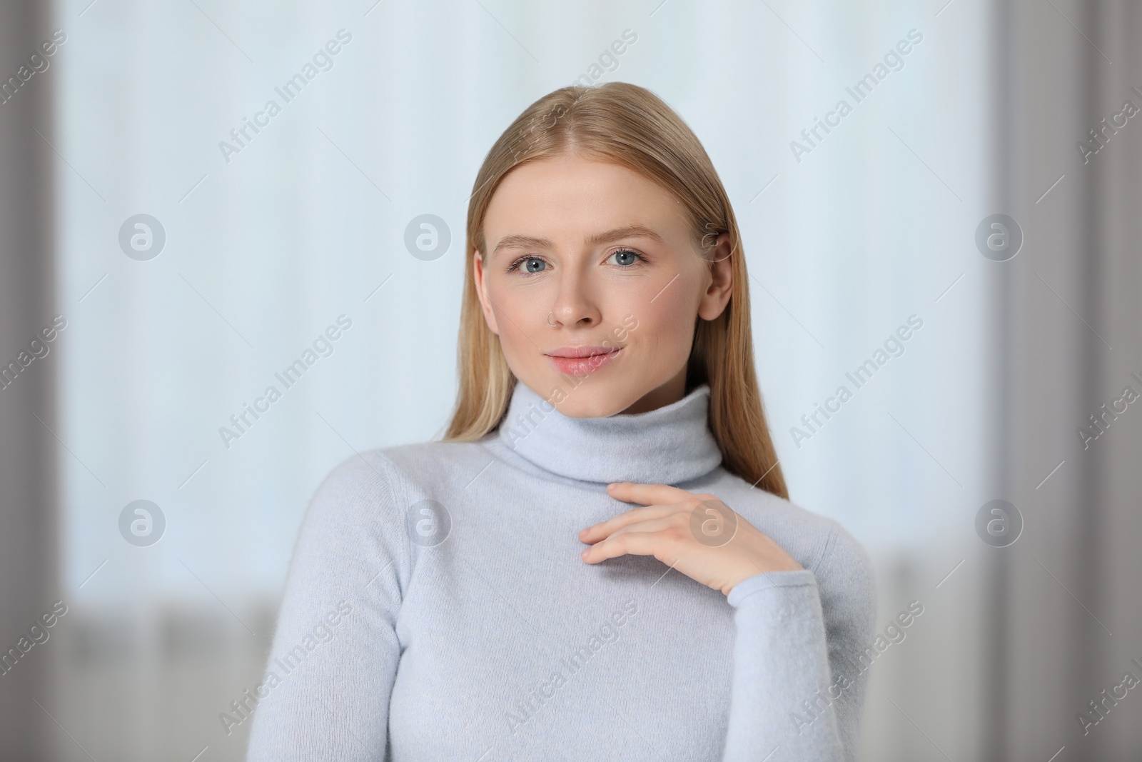 Photo of Portrait of beautiful young woman at home