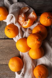 Photo of Tasty fresh tangerines on wooden table, flat lay